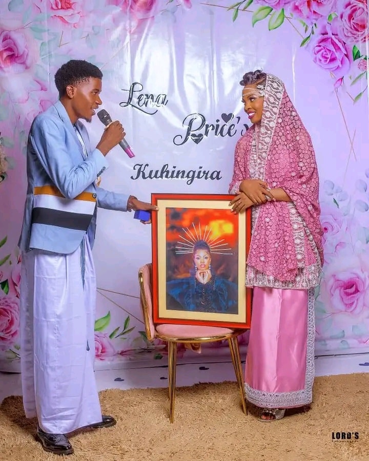 Lena Price and hubby hold a photo during their Kuhingira ceremony