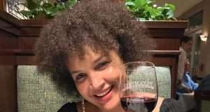 Daniella Atim sipping a on a glas of wine
