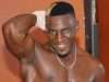 Moses Golola flexing his muscles
