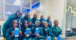 Masaka Kids Africana showing off their passports